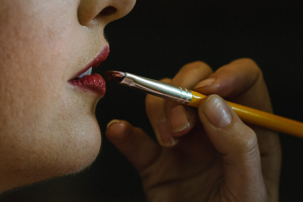 bride getting lipstick applied