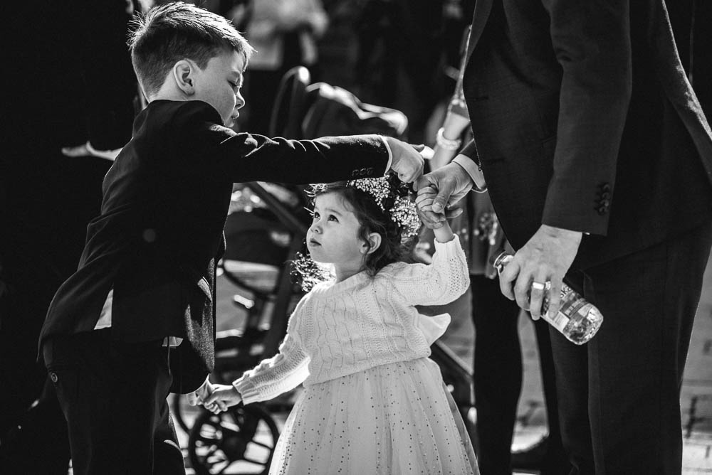 boy helping flower girl
