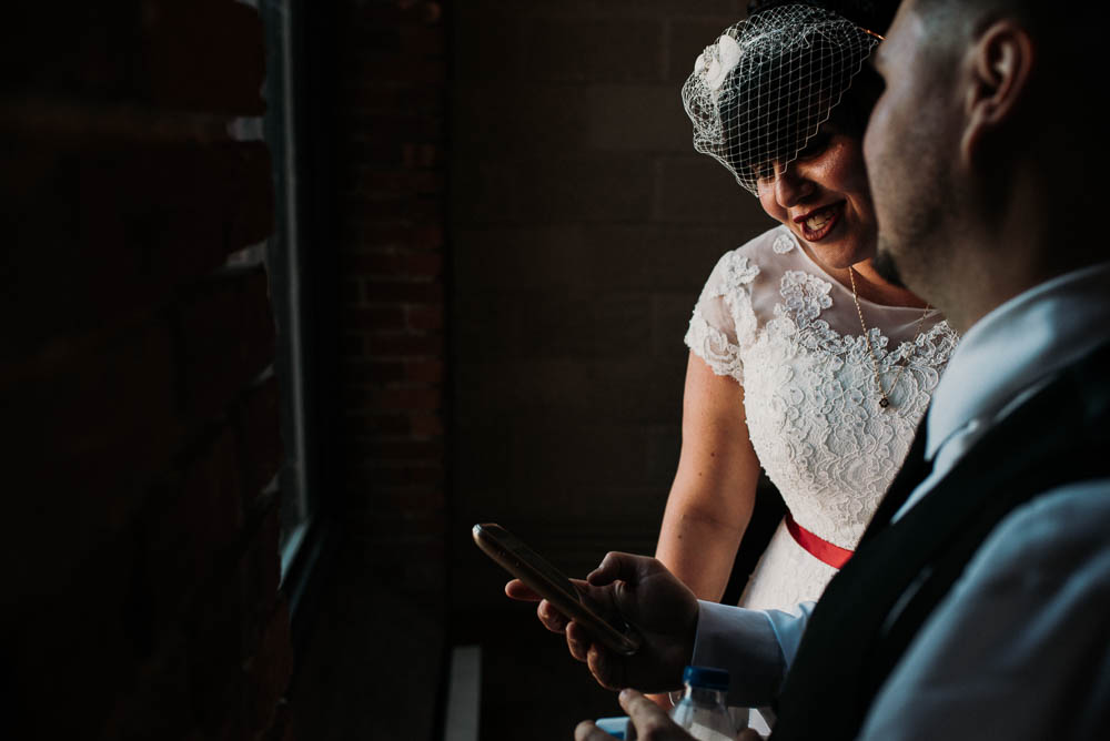 bride looking at phone laughing
