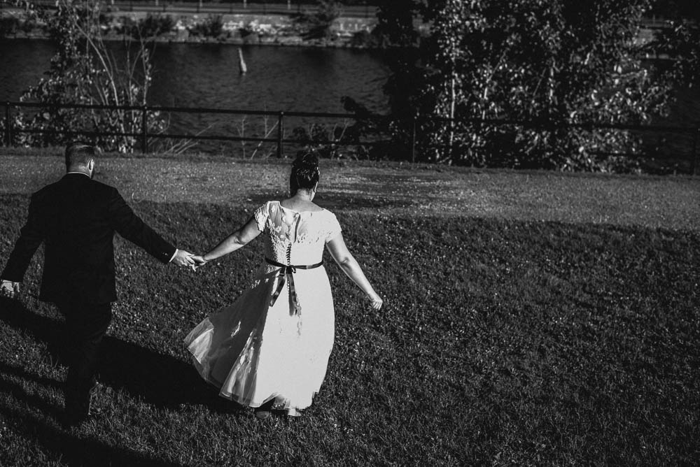 bride and groom walking while holding hands