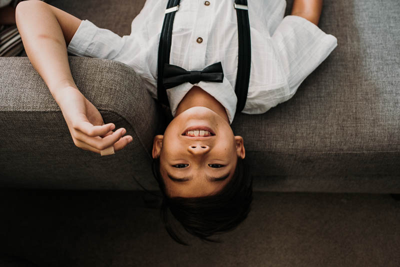 ring bearer hanging upside down on couch