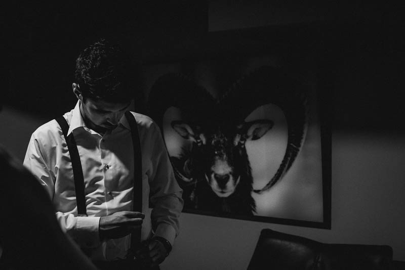groomsman adjusting belt