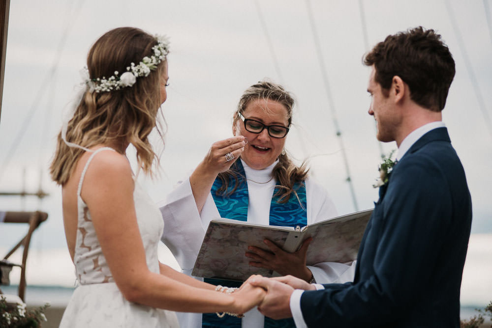 officiant holding wedding bands
