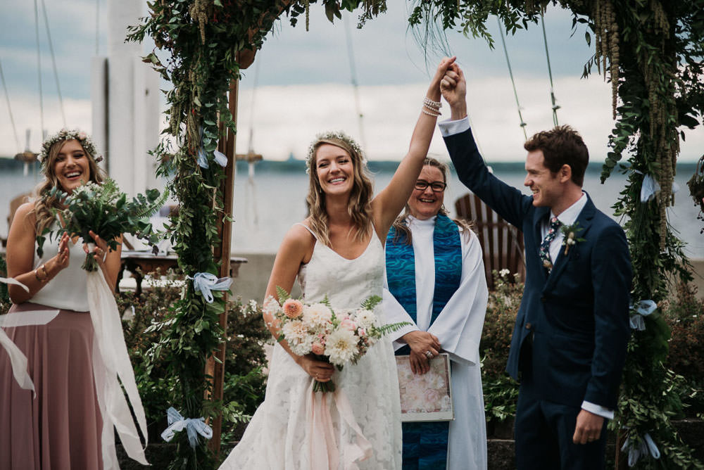 bride and groom fist pumping after ceremony