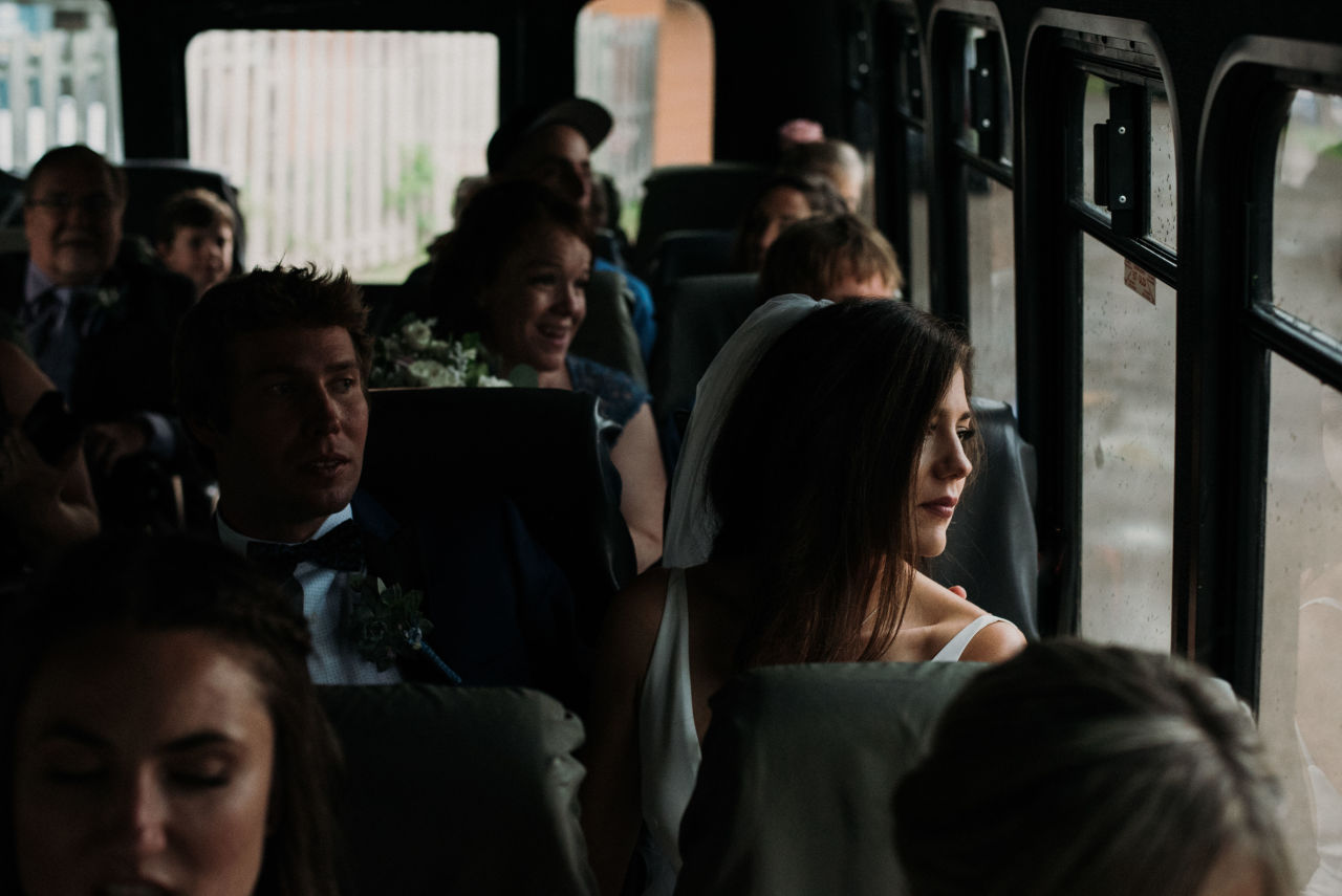 bride looking out of wilderness tours bus window