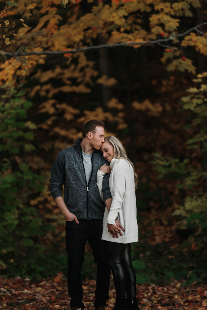 cute engagement photo of guy kissing girl's forehead