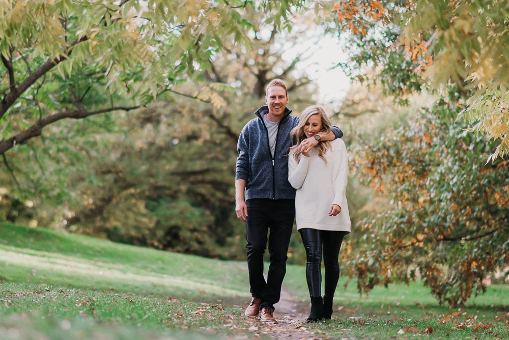 guy has arm around girl while walking