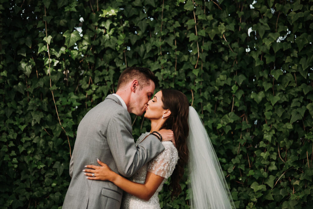 bride and groom first kiss at aquatopia wedding