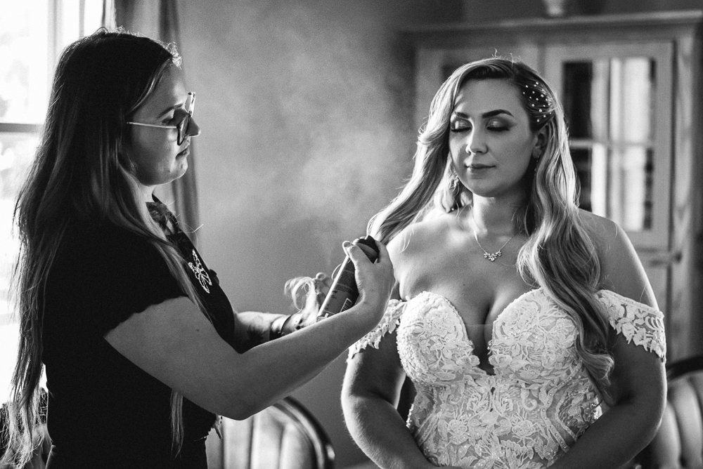 bride getting hair done before tucker house wedding