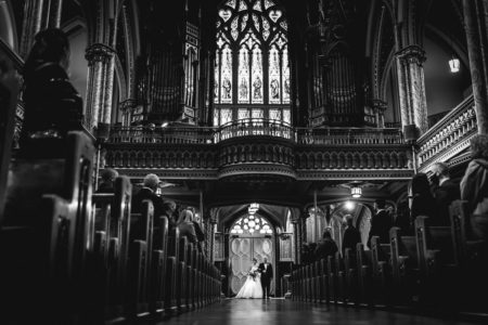 bride walking down aisle with father at Notre dame basilica in Ottawa