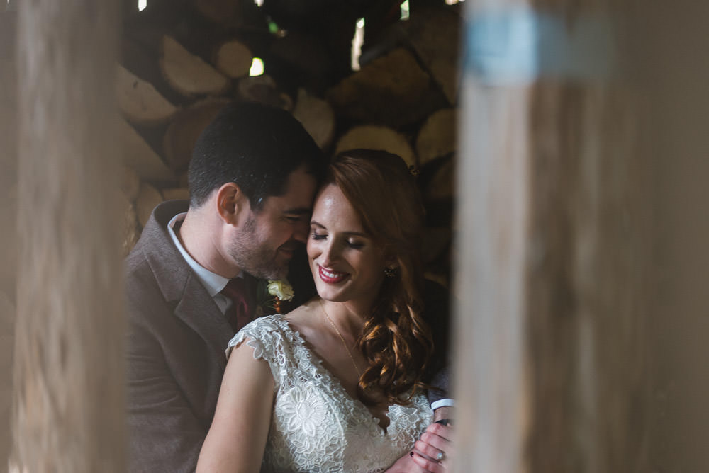 couple portrait of bride and groom in wood shed