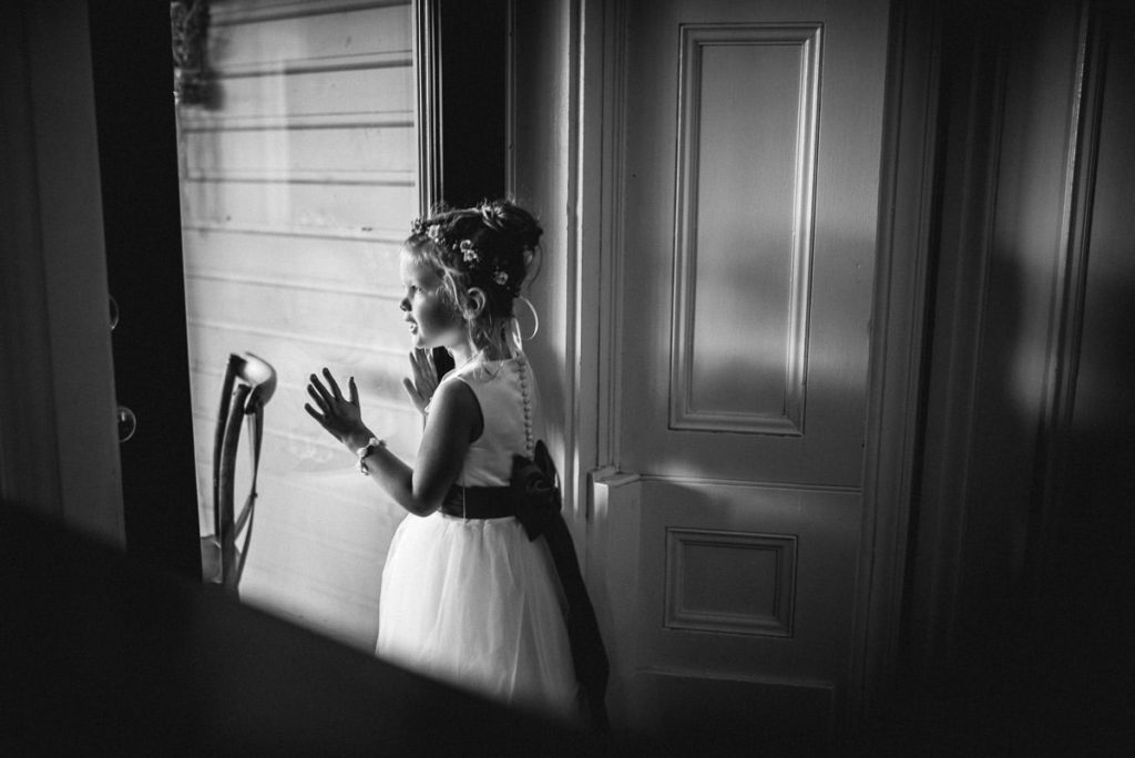 flower girl looking out window