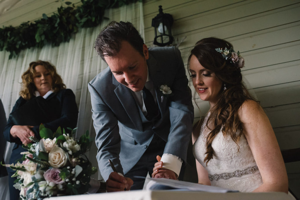 bride and groom signing register