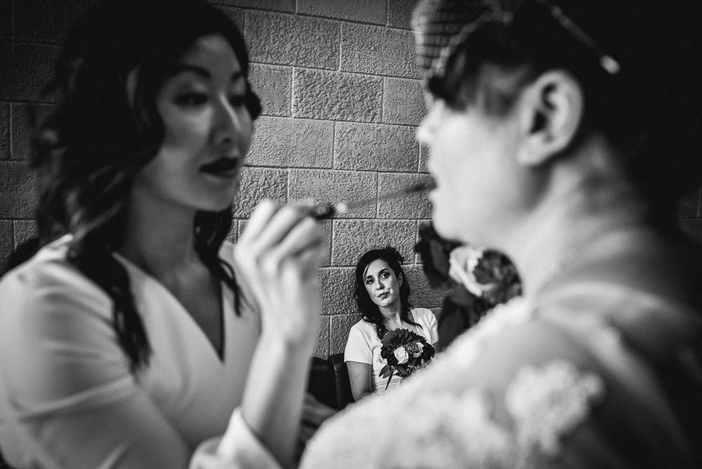 bride getting makeup touchup