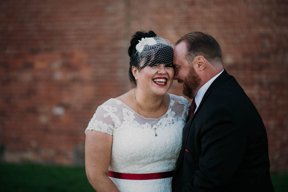 bride and groom portrait while laughing