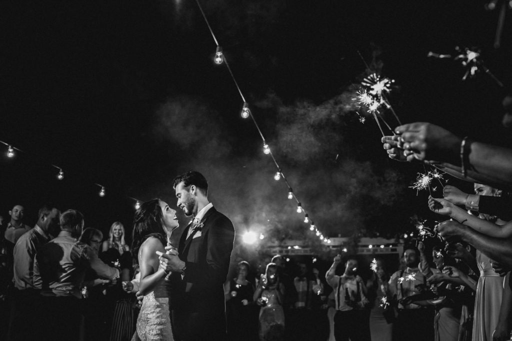 bride and groom first dance under lights during wedding at strathmere
