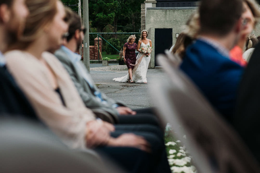 bride walking down aisle with mother