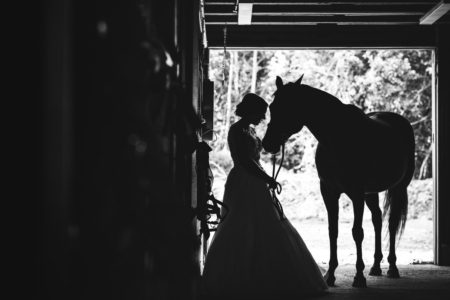 bride with horse in stable