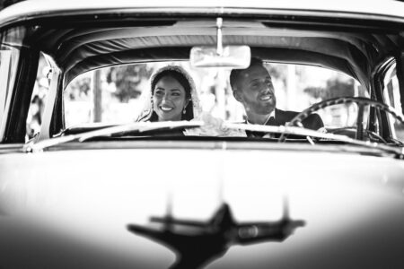 bride and groom smiling in car after wedding ceremony at notre dame basilica